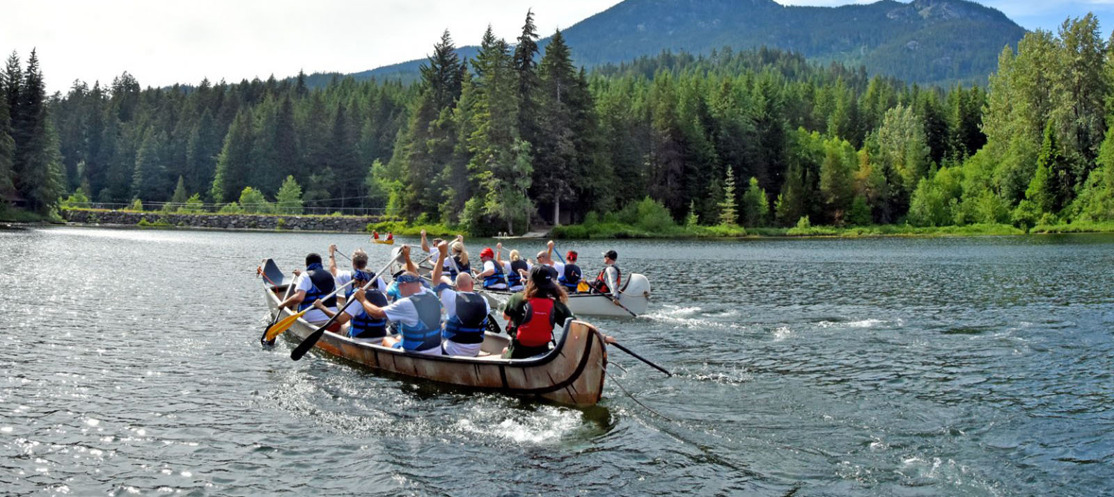 groups paddling voyageur canoes on alta lake